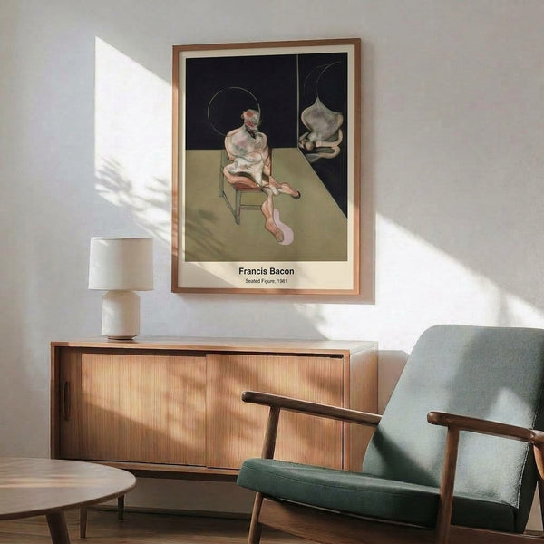 Framed print of an abstract seated figure in muted earth tones and blacks, creating a sense of psychological tension and isolation through its expressionistic treatment.