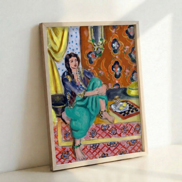 Framed poster of a reclining odalisque rendered in vibrant earth tones and jewel blues, capturing the elegance and sensuality of early twentieth-century modern art.