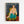 Matisse-style seated female figure in loose garments, surrounded by ornamental wallpaper patterns in warm ochres, blues, and reds, displayed as framed wall art.