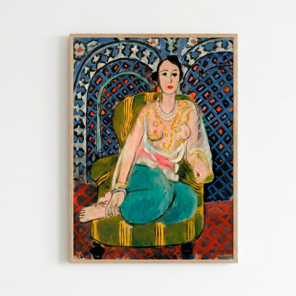 Matisse-style seated female figure in loose garments, surrounded by ornamental wallpaper patterns in warm ochres, blues, and reds, displayed as framed wall art.