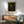 Dignified framed portrait featuring a figure with thoughtful expression in warm brown and shadow tones, minimalist impressionist style.