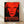 Abstract pop art self-portrait in bold red, black, and white silkscreen style, featuring a haunting monumental face with expressive features on framed wall art.