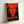 Abstract self-portrait poster with expressive brushwork and layered color fields in bright and moody tones, framed modern art addressing mortality and celebrity.