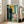 Framed expressionist artwork depicting a shadowed, faceless presence in muted tones surrounded by symbolic elements of time and sleep, conveying emotional depth.