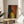 Moody expressionist portrait print showing a figure against turbulent background, executed in muted and shadowy color tones.