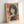 Framed Showa-era inspired portrait print with Art Deco influences, rendered in warm rust and cream hues with cool navy accents for a nostalgic, cinematic mood.