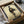 Zen living room poster featuring a mysterious figure in traditional kimono walking, composed in understated woodblock style with cream, grey, and muted tan coloration.