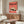 Showa era kitchen wall art depicting a charming rice ball composition with sesame seeds in coral, cream, and brown hues, printed in classic Japanese vintage poster aesthetic.