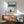Nostalgic ski lodge wall art in classic Showa woodblock style with teal, red, and brown tones illustrating a solitary winter moment in the mountains with food and serene alpine atmosphere.