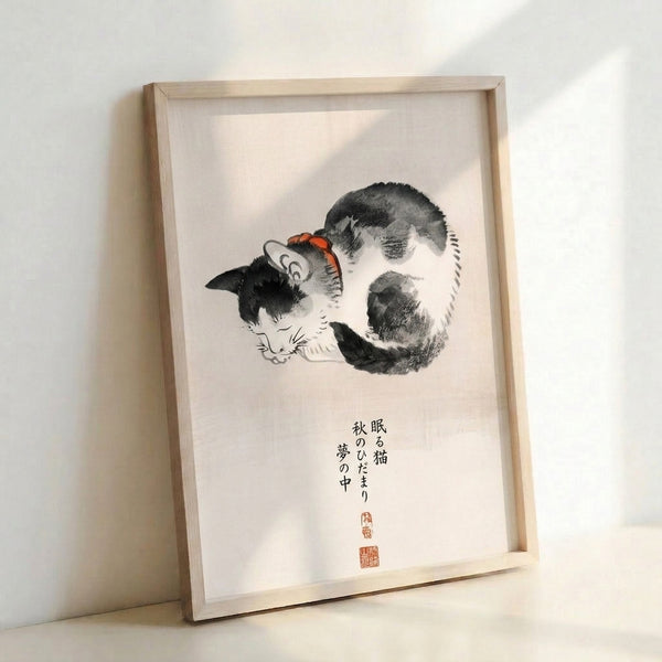 Zen-inspired framed art print showing a resting cat rendered in soft cream and gray with black lines and warm orange-red highlights, accompanied by calligraphic characters.