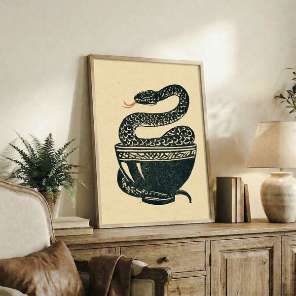 Framed Japanese woodblock poster displaying an intricate snake curled in a vessel, blending whimsigoth aesthetics with traditional art techniques in muted cream and dark teal tones.