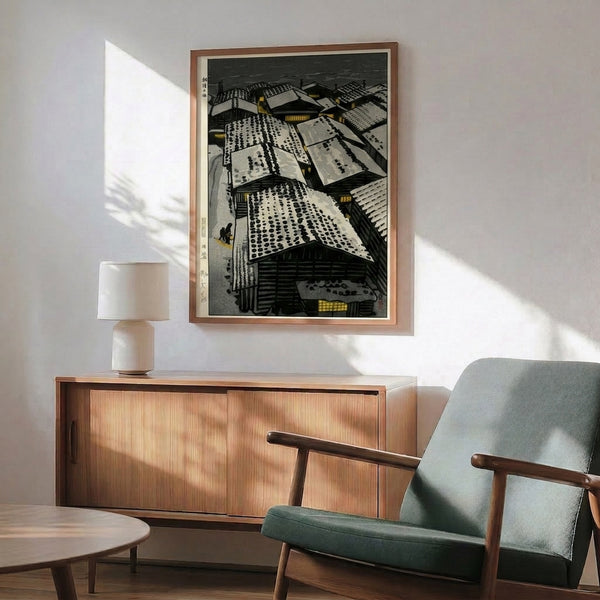 Traditional woodblock-style print showing snow blanketing village rooftops and structures, with warm lanterns casting soft gold light against cool charcoal and cream palette, conveying serene contemplation.