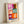 Bright, simplified botanical shapes in blue, yellow, and red arranged in a cheerful abstract pattern, inspired by modernist cut-out techniques.