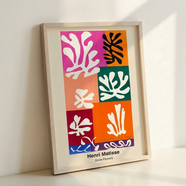 Bright, simplified botanical shapes in blue, yellow, and red arranged in a cheerful abstract pattern, inspired by modernist cut-out techniques.