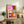 Contemporary abstract poster showcasing organic flower forms in white, red, blue, and yellow creating a light, joyful composition.