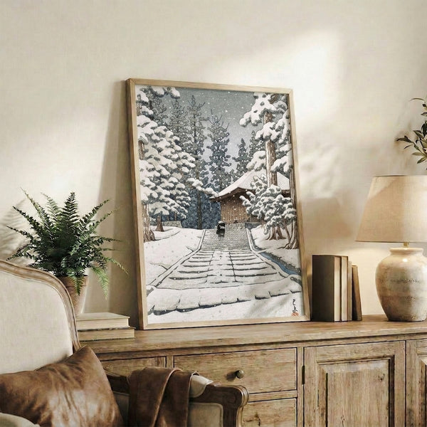 Traditional Japanese woodblock winter scene capturing a temple stairway shrouded in snow beneath towering forest trees, rendered in a contemplative palette of white, cool grays, and earthy browns.