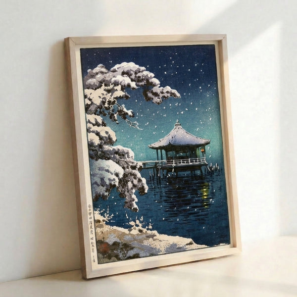 Dark contemplative woodblock artwork depicting a snowy pavilion scene with bare tree branches and peaceful water, palette of charcoal and teal hues.