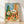Retro western still life poster featuring a cactus, guitar, chair, and hat in warm burnt orange, turquoise, and sage green tones, evoking nostalgic desert wanderlust and bohemian charm.