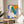 Vibrant abstract poster featuring interlocking cutout shapes in ocean blues and warm accent colors, evoking island memories and seascapes.