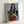 Colorful fauvist art print on a wall showing a Spanish woman playing a tambourine, with dynamic warm and cool tones characteristic of early modern painting.