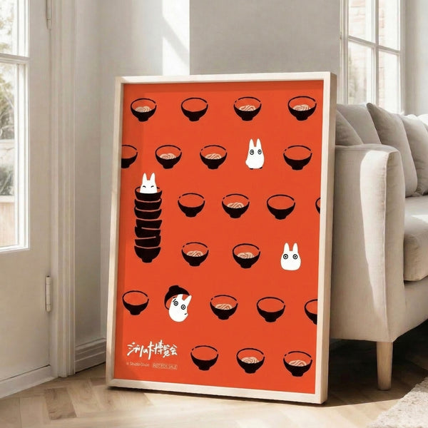 Nostalgic Ghibli-style framed print depicting ramen bowls and spirit characters in a whimsical design, featuring bold red and black artwork on cream.