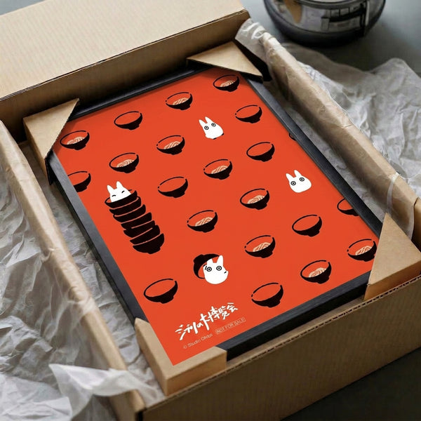 Framed wall art featuring stylized spirit and ramen bowl characters in a whimsical anime illustration, using bold tomato red and black strokes on cream background.