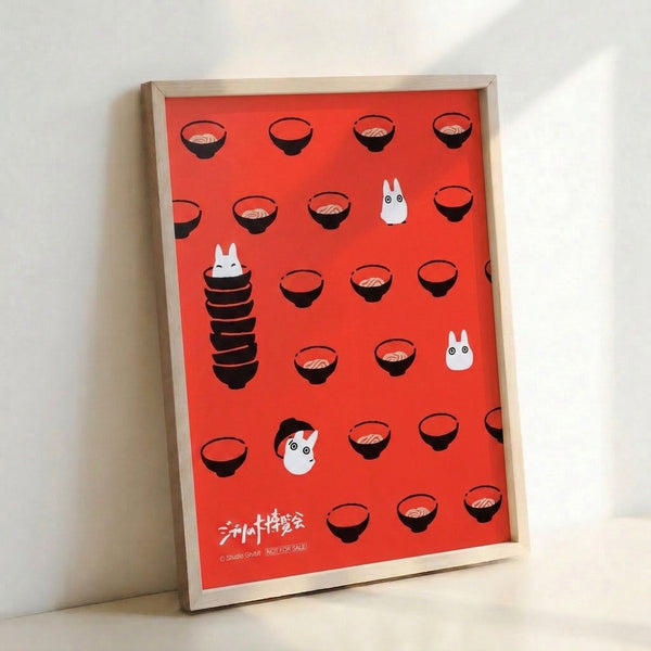 Studio Ghibli-inspired wall print depicting enchanted ramen bowls and spirited characters in bold coral red and black, with a playful yet serene minimalist aesthetic.