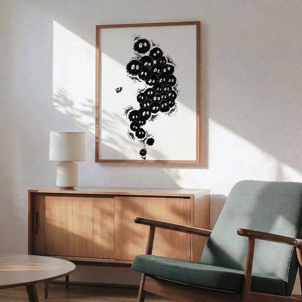 Framed monochromatic poster showcasing speckled soot sprite characters in flowing linework, blending playful and mysterious Ghibli animation aesthetics.