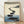 Minimalist watercolor poster of smooth stepping stones leading through calm waters, with soft blue and gray tones evoking a meditative Japandi aesthetic.