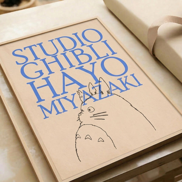 Minimalist Ghibli-inspired framed print showing Totoro rendered in elegant black lines with blue and cream typography celebrating Japanese animation.
