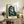 Framed contemporary portrait print featuring distorted head imagery in ochre and black tones, creating an intense and confrontational visual presence.