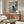 Gestural portrait exploration in subdued palette of grays and warm neutrals, contemporary art print mounted on wall.