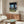 Distorted human body abstraction in cream, charcoal, and warm earth tones, intensely psychological and expressionist as framed wall decor.