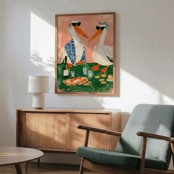 Playful framed poster of a charming pelican with a bow, sipping wine amid festive cupcakes and cookies in a whimsical boho color palette of coral, cream, and green.