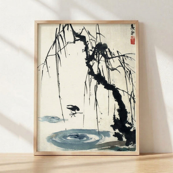 Framed Japanese sumi-e ink wash painting featuring a solitary bird perched on a willow branch overlooking calm water, rendered in black ink and soft blue tones on cream background.
