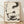 Minimalist sumi-e ink wash poster featuring a serene cat with enso circle, charcoal brushstrokes on cream background, Japanese Zen art print for meditation spaces.