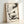 Serene sumi-e painting poster displaying a contemplative cat alongside delicate plant and branch details, rendered in charcoal ink on cream, Zen aesthetic.