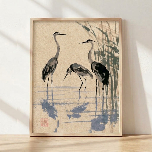Minimalist sumi-e ink wash painting of three herons among reeds in muted blue-gray and black tones, framed and displayed on a wall with serene, meditative aesthetic.