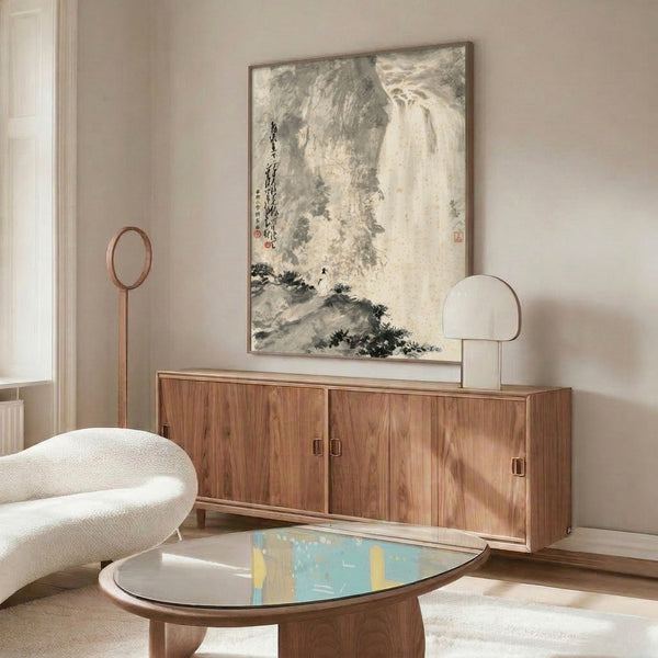 Framed zen-inspired waterfall painting with minimalist composition in charcoal and cream, featuring a contemplative figure amid dramatic cliff landscape and water flow.