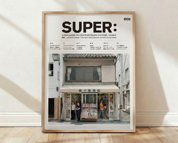 Minimalist framed poster featuring a cream and brown illustration of an Osaka street storefront with figures and architectural details in muted tones.
