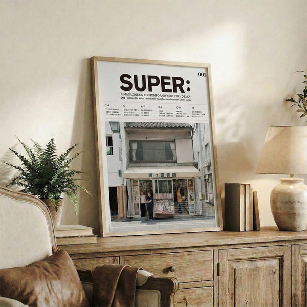 Minimalist framed artwork of an Osaka urban street with shops and passersby captured in soft cream, brown, and gray tones with muted green details.