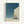 Dreamlike architectural poster showing a lone man climbing stairs that vanish into a moonlit desert expanse, painted in contemplative blues and warm neutrals with a wabi-sabi aesthetic.