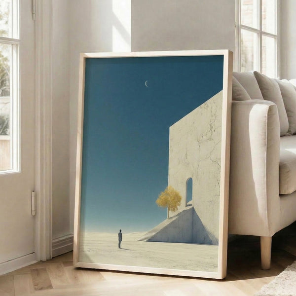 Modern framed print of a contemplative desert scene with a figure on floating stairs beneath moon phases, composed in serene tones of soft blue, white, and ochre.