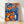 Framed modern art print featuring a surreal composition of koi goldfish swimming among bright oranges and a ceramic bottle, set against cobalt blue and teal tiles in an Art Nouveau style with vibrant, dreamlike mood.