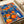 Modern surreal still life poster showing elegant koi fish among oranges and botanical elements in rich blues and warm oranges, framed as kitchen or dining room decor with dreamlike, vibrant energy.