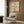 Fantasy poster with precious jeweled mushroom garden design including blooming flowers, moss, and golden sphere elements in muted blush, sage, and cream colors on a wall.
