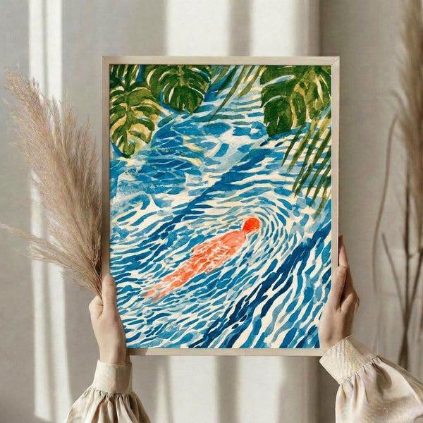 Framed zen art print featuring a peaceful swimmer floating in blue water beneath large leafy foliage, rendered in soft watercolor with Japanese woodblock influences and a calming palette of greens, cream, and coral accents.