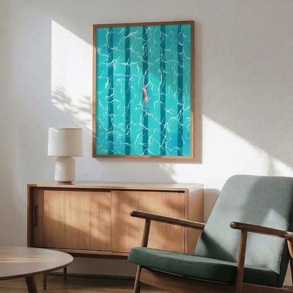 Contemporary framed poster showing an overhead perspective of a contemplative swimmer in tranquil turquoise water with delicate seaweed details in coral pink and white.