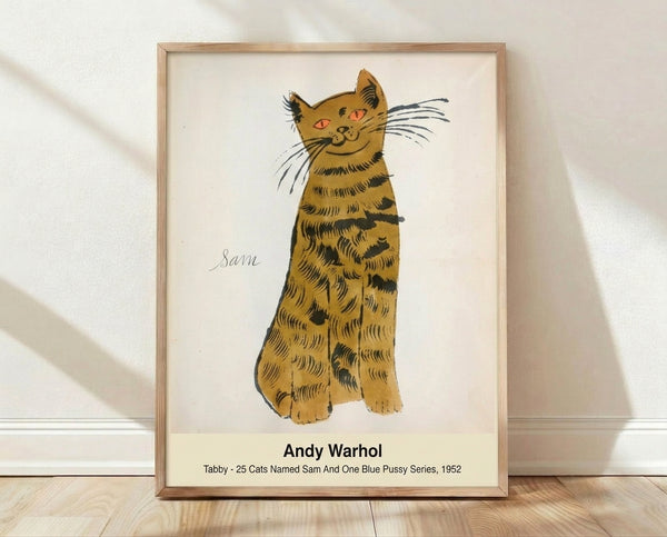 Pop art framed poster of a tabby cat in Warhol style, rendered in warm gold, soft orange, cream, and black tones with whimsical, nostalgic character.