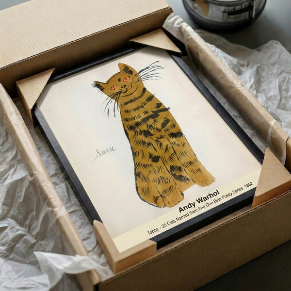 Framed pop art interpretation of a tabby cat in cream, soft orange, and gold with black accents, evoking playful, nostalgic warmth on the wall.